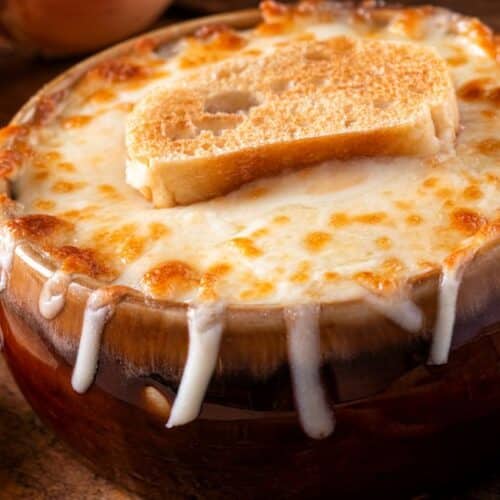 Tigela de sopa de cebola francesa gratinada com queijo derretido e pão.