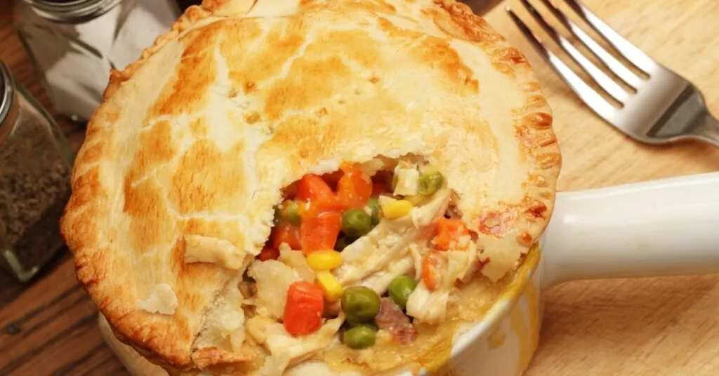 torta de legumes com massa dourada e recheio colorido, comida de festa junina salgada.